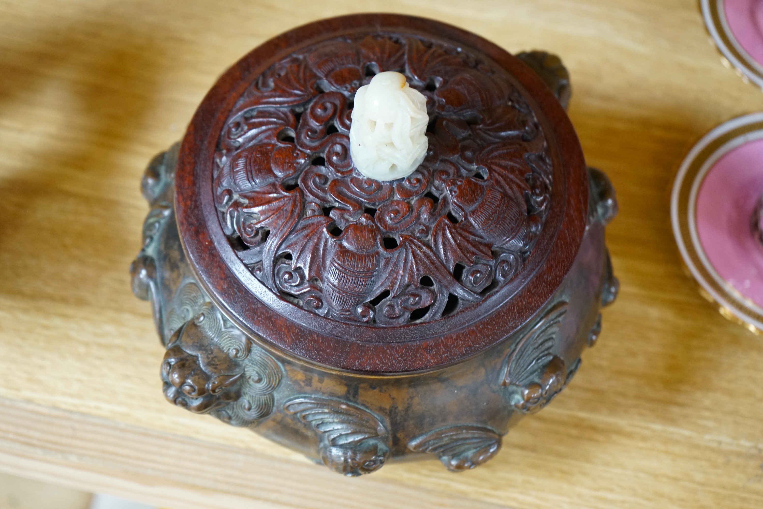 A Chinese bronze censer, with carved wooden cover and jade finial, 17cm high. Condition - good